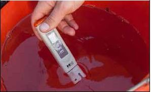 Checking the pH level in water using a digital meter