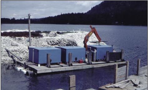 Setting tanks at a site in British Columbia, Canada. Note the loose cultch and vexar bags filled with cultch stacked on the bank behind the tanks